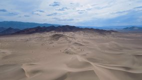 Aerial footage Mojave Desert Southern California Dumont Dunes with mountains in distance