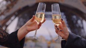 Close up shot of two young girls standing in centre of Paris on sunset, drinking champagne, communicating. Europe travel concept. Friends having fun near Eiffel Tower, clinking glasses. Slow motion - Powered by Shutterstock - Get 15% off with code: PIKWIZARD15