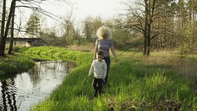 Grandmother and grandson are walking in the park. Happy together. The warmth and love of parents. High quality 4k footage