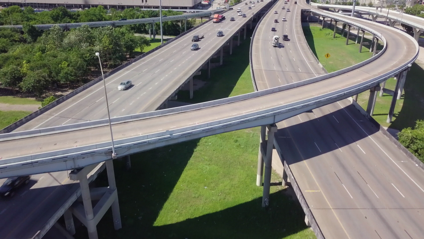 Establishing drone shot of Downtown Houston from I10 and I45 intersection. Revealing aerial shot downtown Houston with high skyscrapers. Intro video of Houston. Downtown transportation in sunny day Royalty-Free Stock Footage #1095410759
