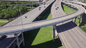 Establishing drone shot of Downtown Houston from I10 and I45 intersection. Revealing aerial shot downtown Houston with high skyscrapers. Intro video of Houston. Downtown transportation in sunny day