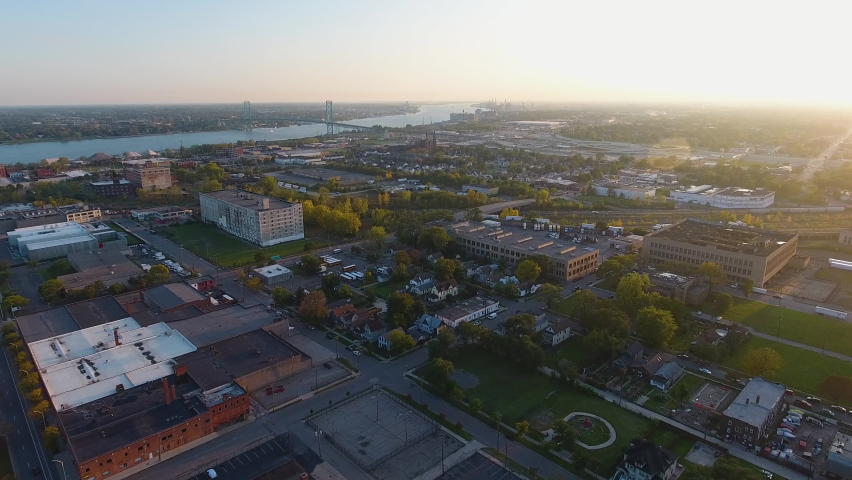 Drone footage of downtown Detroit Michigan along the Detroit River and Ambassador Bridge at sunset
