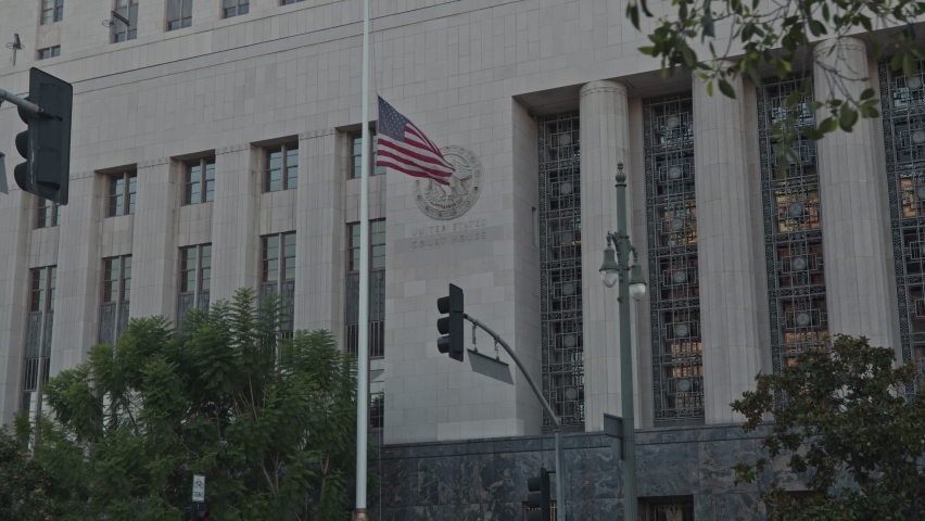 Close up American flag flying outside government building in California