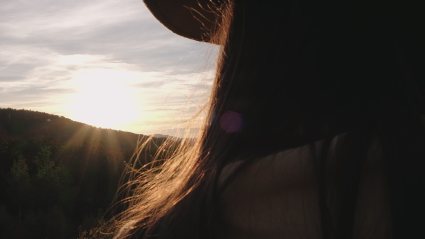 Close up of young female in hat holding happy smiley face on background epic sunset in autumn mountains good feedback rating and positive customer review, satisfaction survey, mental health assessment
