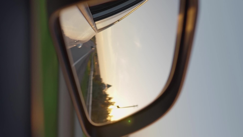 Vertical Video, View from the side window of a car driving fast along the highway during a beautiful sunset. Travel trip and adventure concept. Royalty-Free Stock Footage #1095416709
