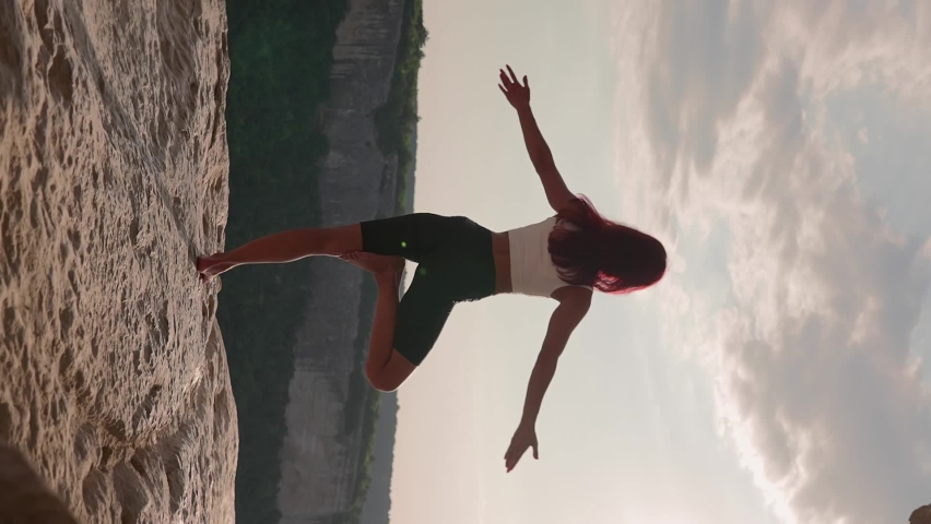 Vertical Video, Athletic Woman Performs Spiritual Yoga Pose on Mountain Top Sunset. Healthy Lifestyle and Zen. Slim Girl Goes in for Sports Outdoors in Beautiful Natural Place. Freedom, Slow Motion Royalty-Free Stock Footage #1095416729