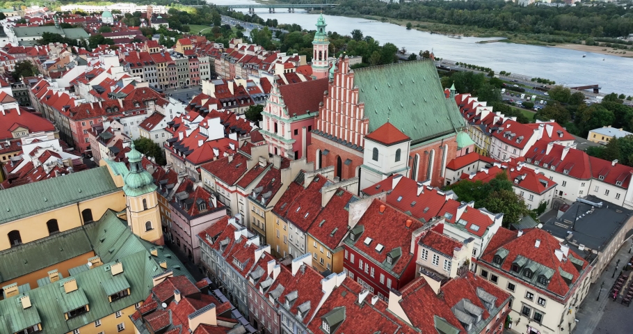 Flyover above Warsaw Old Town buildings and church towards Market Square, Poland, a Buildings & Landmark Video by marchello74