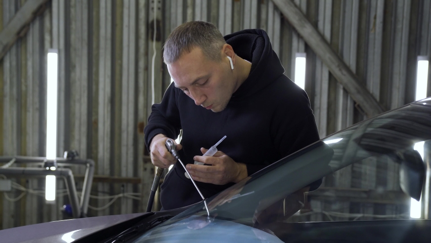 Master Blows Dust From Car Glass. Scola Repair | Shutterstock HD Video #1095428819