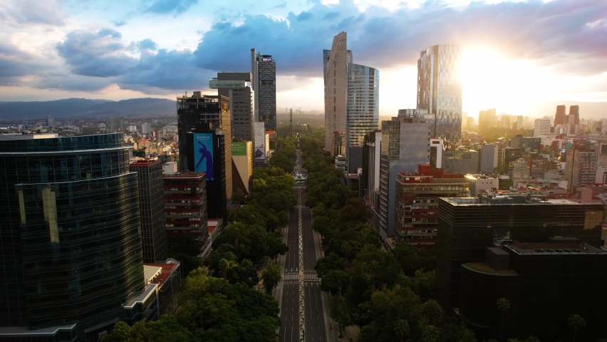 drone shot in reverse of a sunset on the paseo de la reforma in mexico city