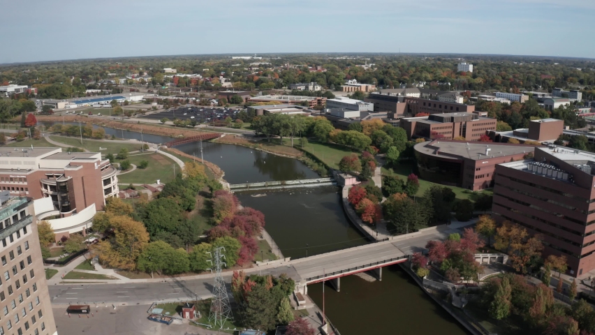 Flint River in Flint, Michigan drone video moving down.