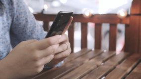 Women holding cell phone using smartphone device in a street cafe. Woman blogger subscribing new social media, buying in internet, ordering products online in apps. - Powered by Shutterstock - Get 15% off with code: PIKWIZARD15