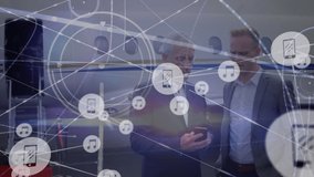Animation of network of digital icons over two caucasian businessmen discussing at airport. Global networking and business technology concept - Powered by Shutterstock - Get 15% off with code: PIKWIZARD15