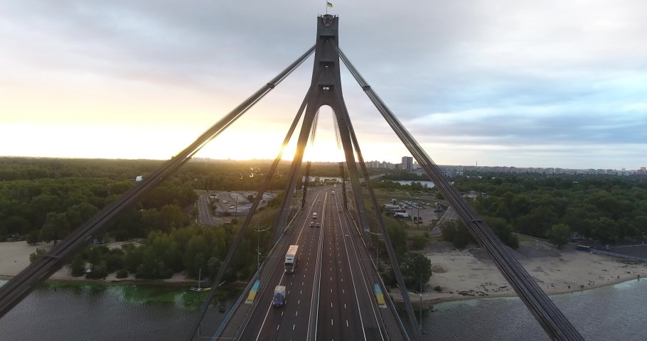 Aerial drone view View Of North or Moscow Bridge Kiev. Ukraine over Dnieper. City view. Traffic on the bridge. Span between the pylons of the bridge.  Royalty-Free Stock Footage #1095448513