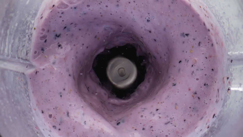 Closeup berries fruits falling purple smoothie blending in electric mixer. Top view strawberry blueberry banana pomegranate dropped into juicy drink super slow motion. Vitamin ingredients for yogurt Royalty-Free Stock Footage #1095473267