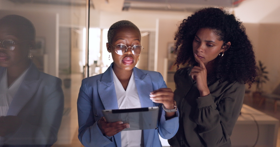 Business leader, black woman on a tablet working at night and coaching or mentoring employee with project feedback. Manager in office, corporate leadership and employees digital brainstorm together Royalty-Free Stock Footage #1095473413
