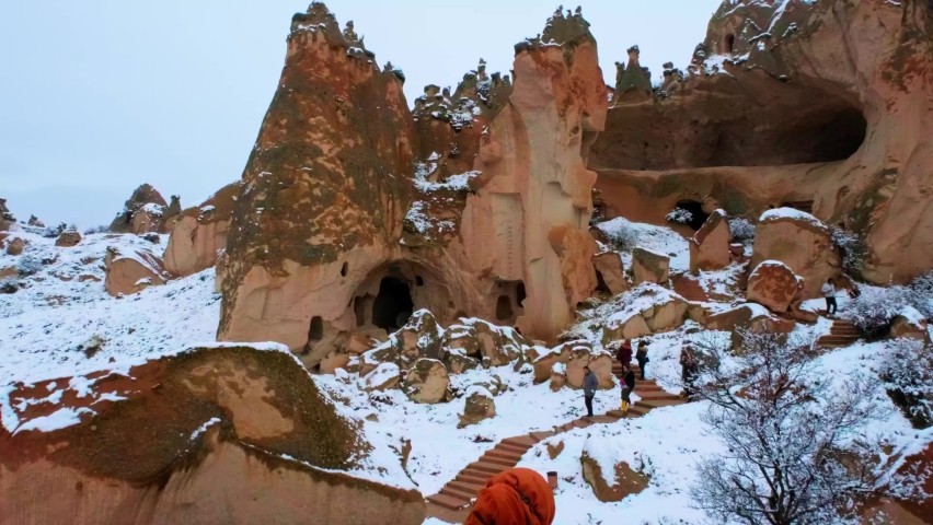 Snowy Natural Rock Formations and Walking People