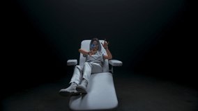 Smart teen touching invisible interface in VR glasses. Blonde haptic sensors gamer playing surrounded with futuristic metaverse nft data dark background. Augmented reality, future technology concept - Powered by Shutterstock - Get 15% off with code: PIKWIZARD15