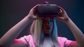 Impressed woman take off vr glasses closeup. Millennial girl excited after new 3d simulation experience slow motion. Female person enjoying gaming entertainment colourful neon cyberpunk background - Powered by Shutterstock - Get 15% off with code: PIKWIZARD15