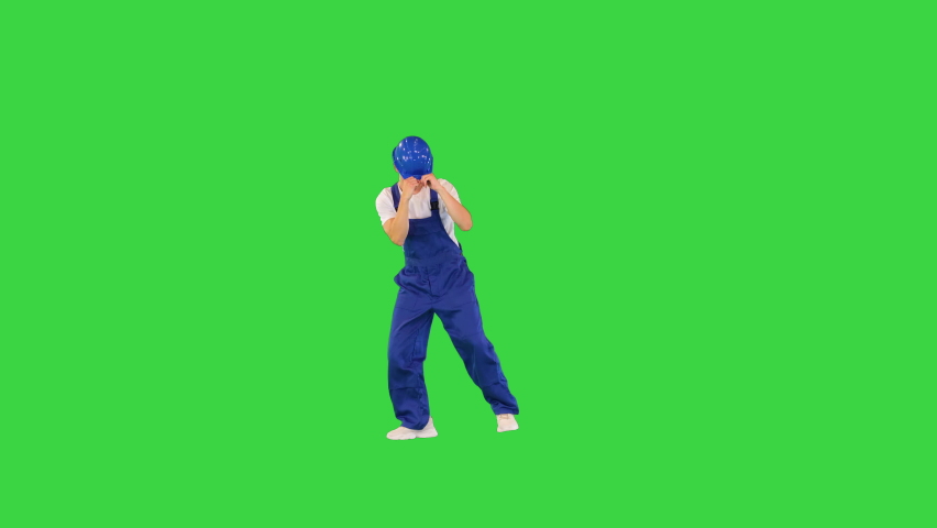 Happy and excited construction worker dancing on a Green Screen, Chroma Key. Royalty-Free Stock Footage #1095487571