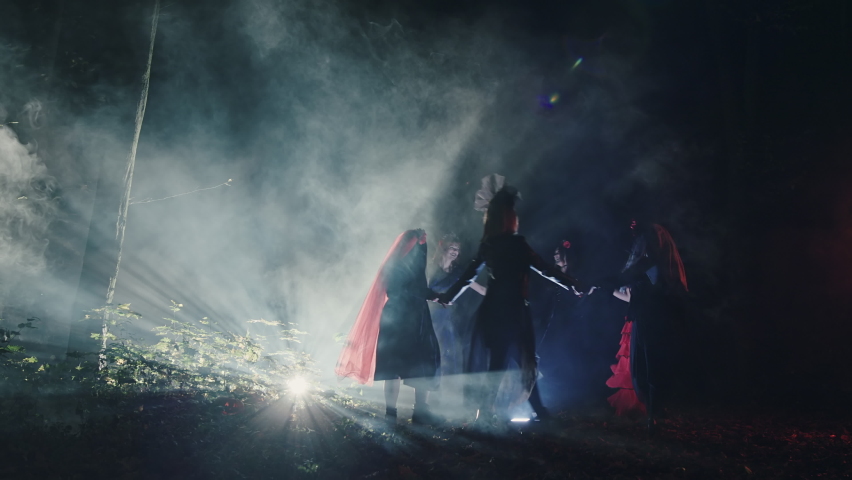 Witches dancing in circle at night