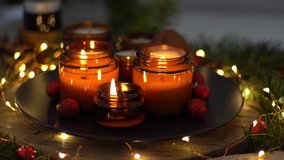 Soy candles burn in glass jars. Comfort at home. Candle in a brown jar. Scent and light. Scented handmade candle. Aroma therapy. Christmas tree and winter mood. Cozy home decor. Festive decoration. - Powered by Shutterstock - Get 15% off with code: PIKWIZARD15