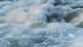 Abstract timelapse video - long exposure shots of water flowing in river over rocks