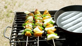 Making chicken meat skewers on barbecue