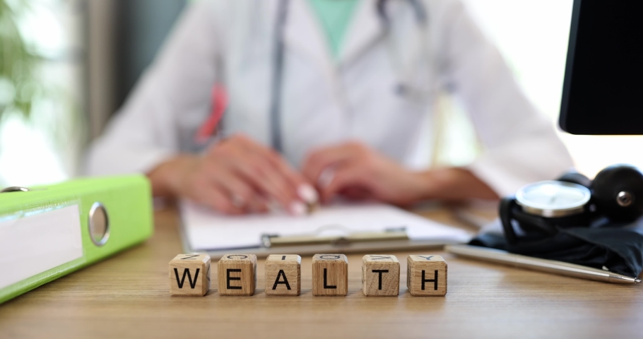 Health and wealth on cubes on the doctor's table, close-up Royalty-Free Stock Footage #1095508769