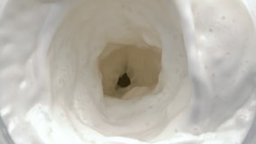 Lactose beverage swirling moving top view. Clean milk rotating in slow motion. Fresh dairy liquid vortex with waves closeup. Tasty milkshake cocktail making funnel. Creamy calcium drink whirlpool - Powered by Shutterstock - Get 15% off with code: PIKWIZARD15