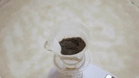 video while pouring hot boil water into fresh grinded coffee bean for making brewed drip coffee homemade for breakfast morning beverage drink
