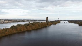Aerial View of Riga City the Capital of Latvia. Amazing View on the River Daugava, Old Town, National Library, Bridges Over the River and the Main Tv Tower. View From Above During Autumn Cloudy Day 4K