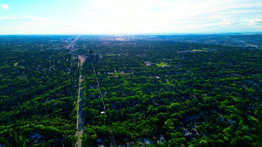 102 Avenue Stony Plain Rd drone aerial flyover Glenora neighborhood towards Grovenor 142 St NW lush green trees birds eye top view clear blue sunny summer sky downtown Edmonton West Mackinnon1-3