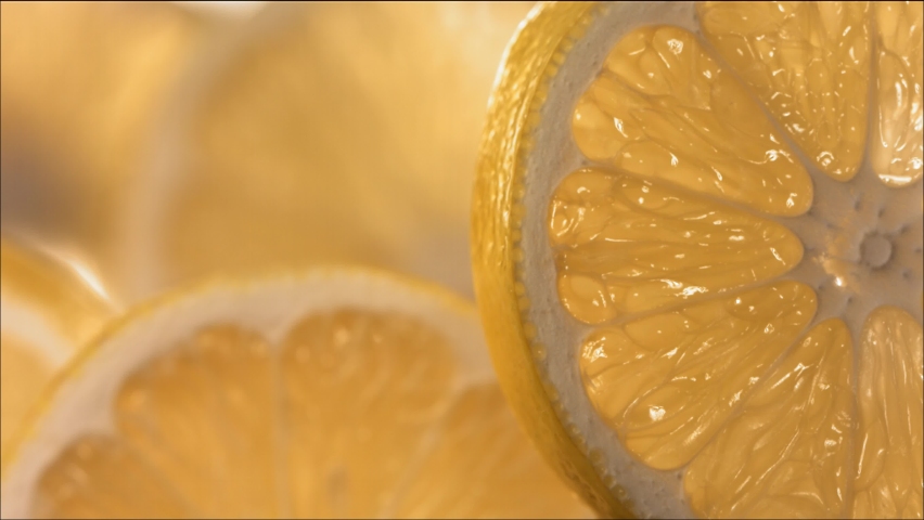 Drop of Water flow down the surface of a ripe juicy Lemon slice. Slow Motion 4K Royalty-Free Stock Footage #1095536387
