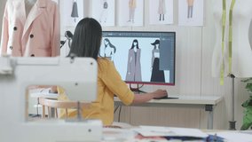 Back View Of A Female Designer Designing Clothes On A Desktop In The Studio. Dress Production Procedure Concept. Cyber Games Clothing And Designing
