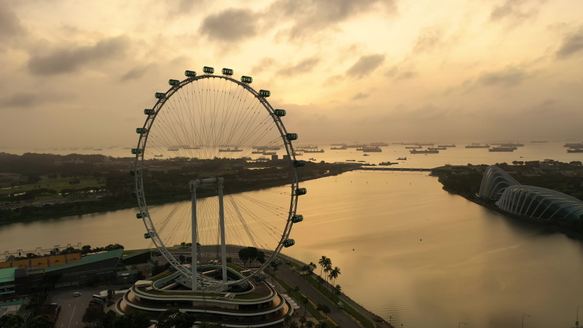 Drone Aerial view 4k Footage of Singapore Flyer. sunrise Royalty-Free Stock Footage #1095544091