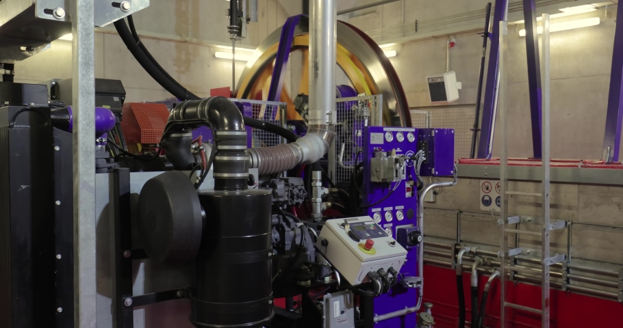 Big flywheel spinning in the industrial engine room of a cabin ski lift