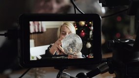Camera monitor during shooting of Christmas video commercial.