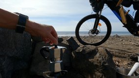 Young adventurer man preparing coffee on the beach - Powered by Shutterstock - Get 15% off with code: PIKWIZARD15