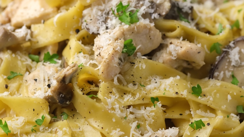 Creamy Alfredo pasta with chicken, mushrooms and parmesan cheese. Rotating video