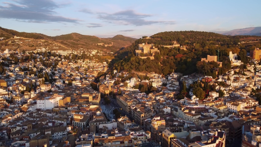 Granada, Spain: Aerial drone footage of the Granada old town with the famous Alhambra citadel and palace and the Plaza Nueva de Granada in Andalusia in southern Spain in late afternoon.  Royalty-Free Stock Footage #1095547473