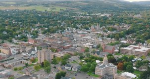 Early fall late afternoon aerial video of the downtown streets, City of Cortland NY, Cortland County, USA.  