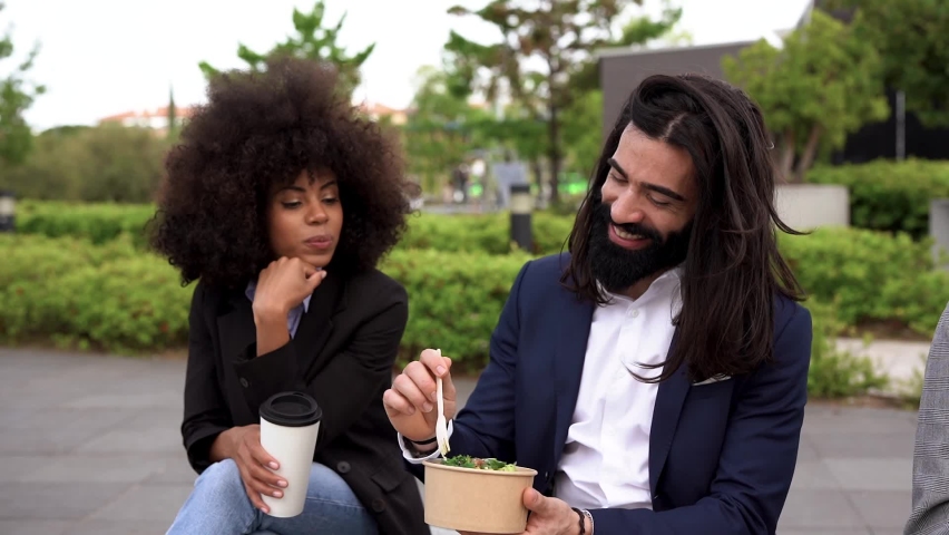 Multiracial business people eating healthy poke outdoor