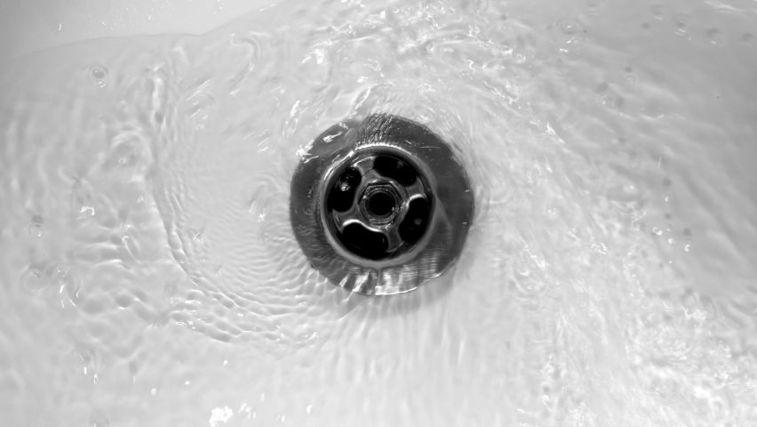 Water flows down in sink drain hole. slow motion water drain in sink. stream of water going down into drain, close up. water starts to flow and ends at end of footage. utilities. sewage. | Shutterstock HD Video #1095555485