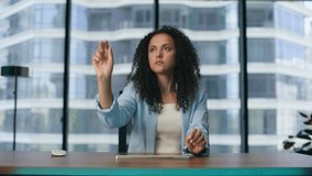 Woman manager using augmented reality software interface for operating business in futuristic office close up. Latin american brunette girl touching invisible digital screen working in metaverse.  - Powered by Shutterstock - Get 15% off with code: PIKWIZARD15