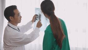 Group of team doctors checking and examining x-ray film about bone and skeleton of patient for checking disease while discussion at hospital, doctors and assistant talking together, medical concept. - Powered by Shutterstock - Get 15% off with code: PIKWIZARD15