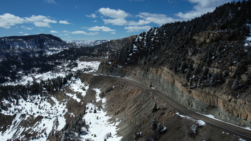 Aerial View of Douglas Pass, Colorado USA, Road on Scenic Route on Sunny Winter Day