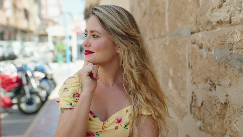 Young beautiful hispanic woman smiling confident standing at street