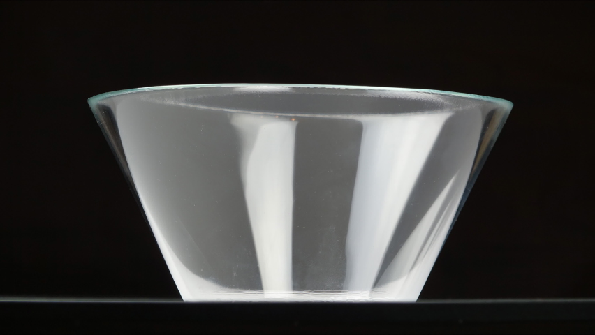 Filing bowl with pieces of fresh different fruits, black background, healthy