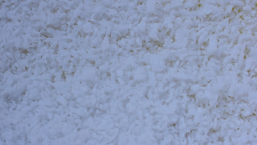 Polystyrene beads wind blowing yellow background with space for text