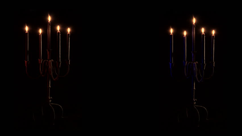 Two matching candelabras softly flicker in the dark.